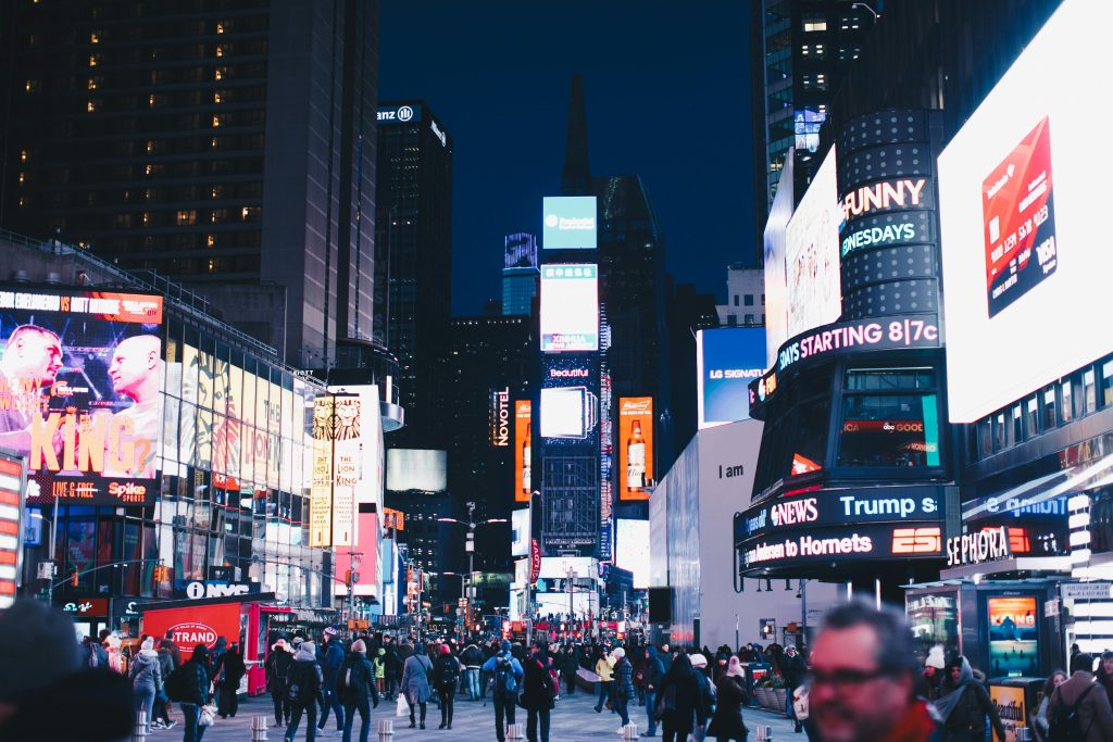 Times Square in New York City at night with illuminated billboards and crowds